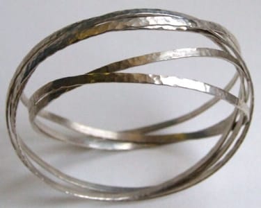 Tensioned hammered sterling silver ribbon bracelet