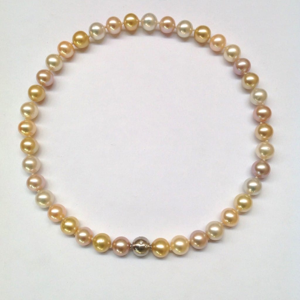 Pink freshwater pearls with white and golden South sea pearls, 10mm in diameter. 18 carat white gold clasp studded with 12 diamonds.