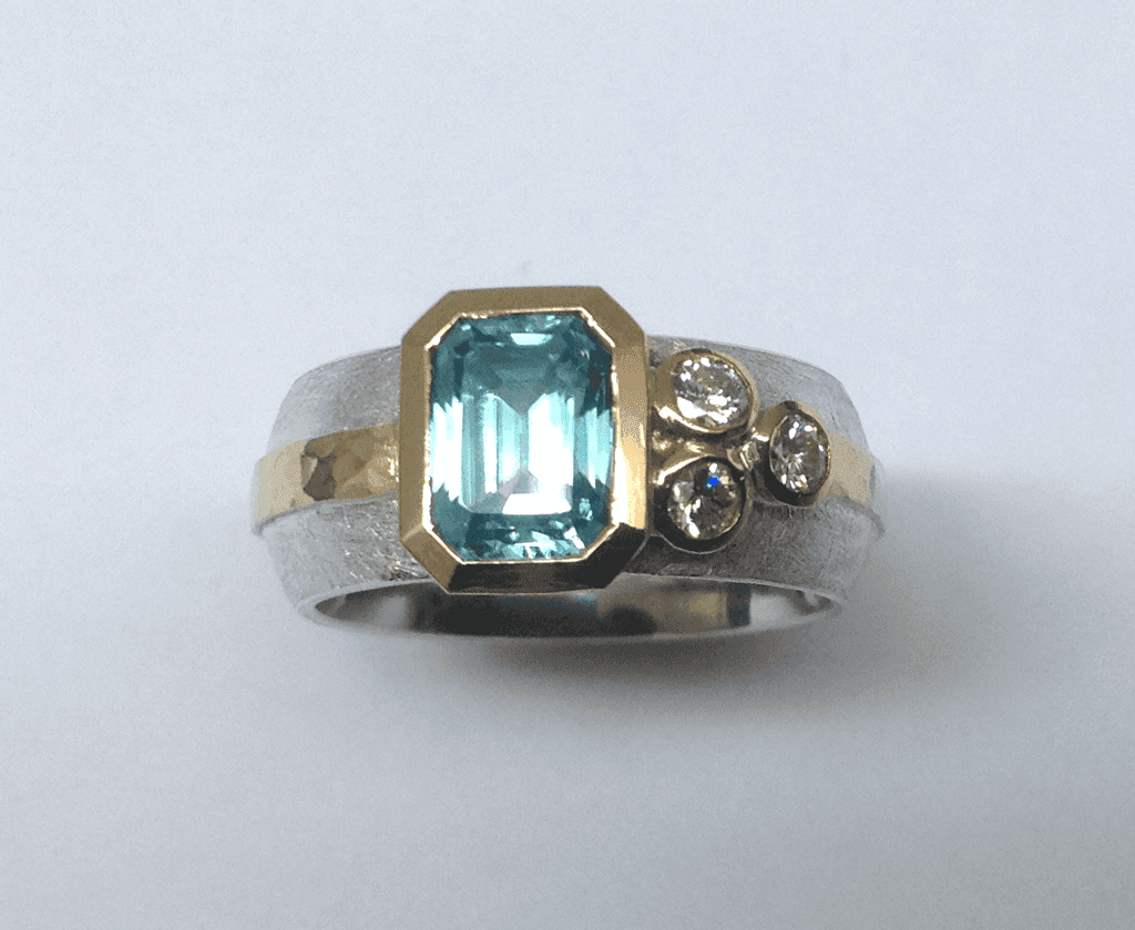 Sterling silver, 18 carat yellow gold, blue zircon diamonds
