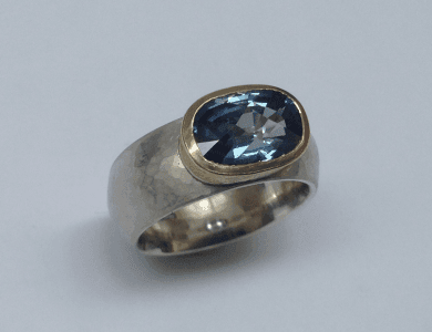 Sterling silver, 18 carat yellow gold, blue sapphire