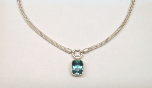 Sterling silver, 18 carat yellow gold, aquamarine