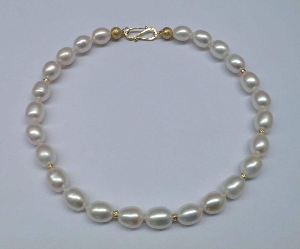Oval white freshwater pearls, 18 carat yellow gold beads and clasp