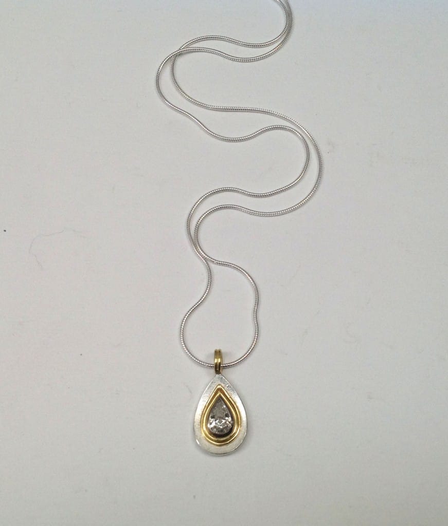 0.8 carat grey drop shape diamond set in 18 carat yellow gold, sterling silver base and chain