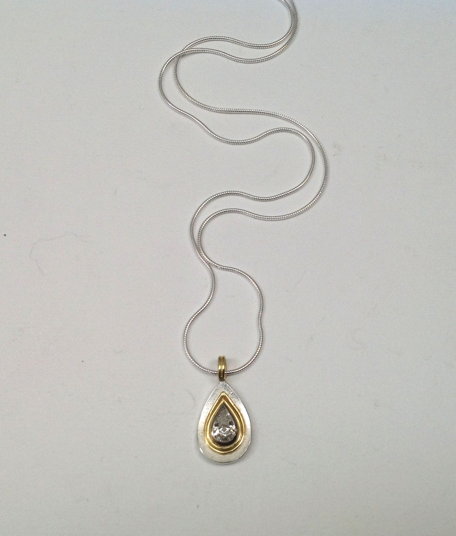 0.8 carat grey drop shape diamond set in 18 carat yellow gold, sterling silver base and chain