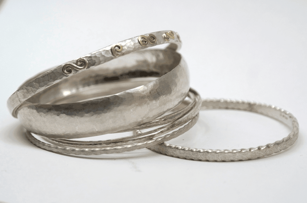 Collection of sterling silver bangles including with gold detail
