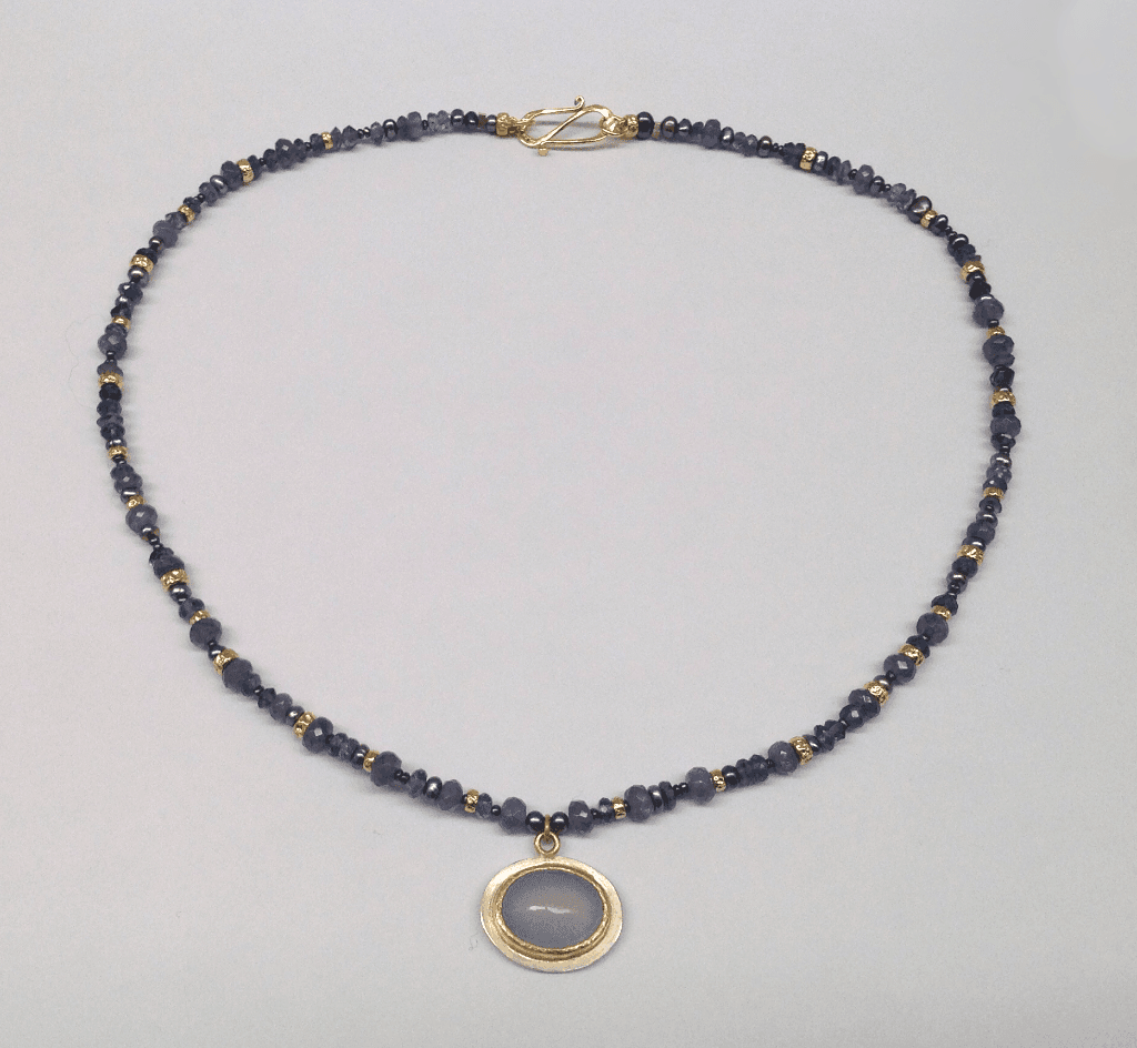 Chalcedony set in 18 carat yellow gold and sterling silver, sapphire, tanzanite and 18 carat yellow gold beads and peacock pearls