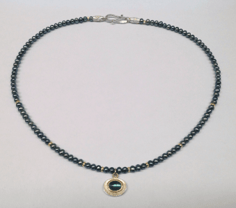 Indigolite set in 18 carat yellow gold, sterling silver, peacock pearls, 18 carat yellow gold beads