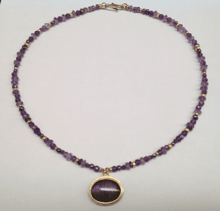 Purple labradorite set in 18 carat yellow gold, amethyst and 18 carat yellow gold beads, peacock pearls