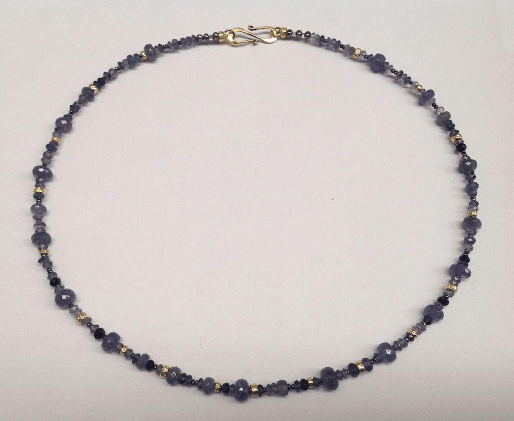 Tanzanite, sapphire, iolite, and 18 cart yellow gold beads, peacock pearls