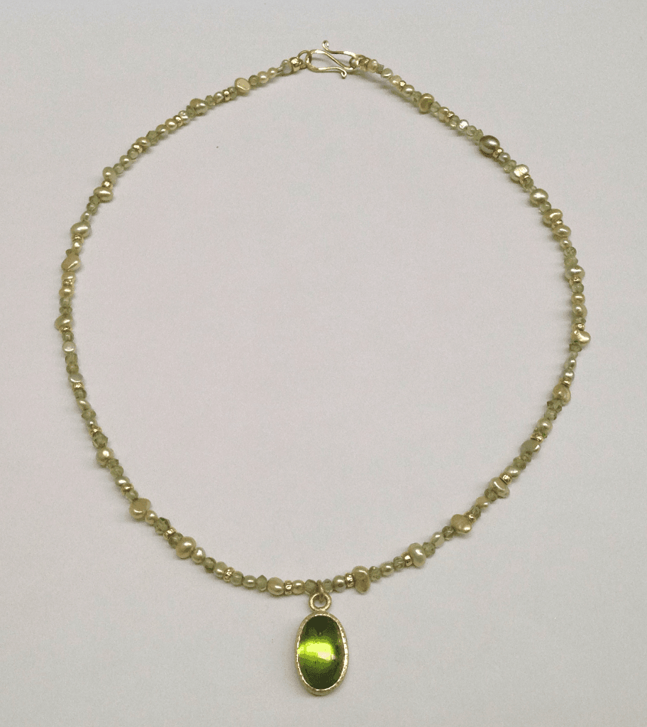 Peridot set in 18 carat yellow gold, peridot beads, freshwater pearls