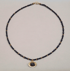 Blue tourmaline set in 18 carat yellow gold, sterling silver, lapis lazuli and 18 carat yellow gold beads, peacock pearls