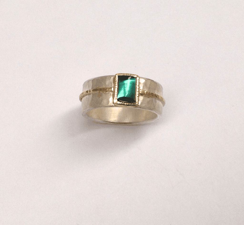 Green tourmaline set in 18 carat yellow gold, sterling silver