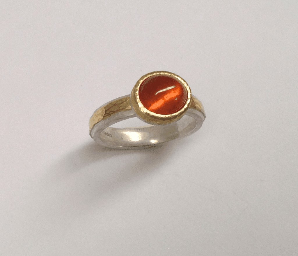 Mandarin garnet set in 18 carat yellow gold, sterling silver