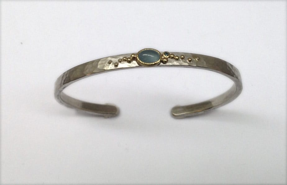 Sterling silver and 18 carat yellow gold bangle with aquamarine and blue diamond